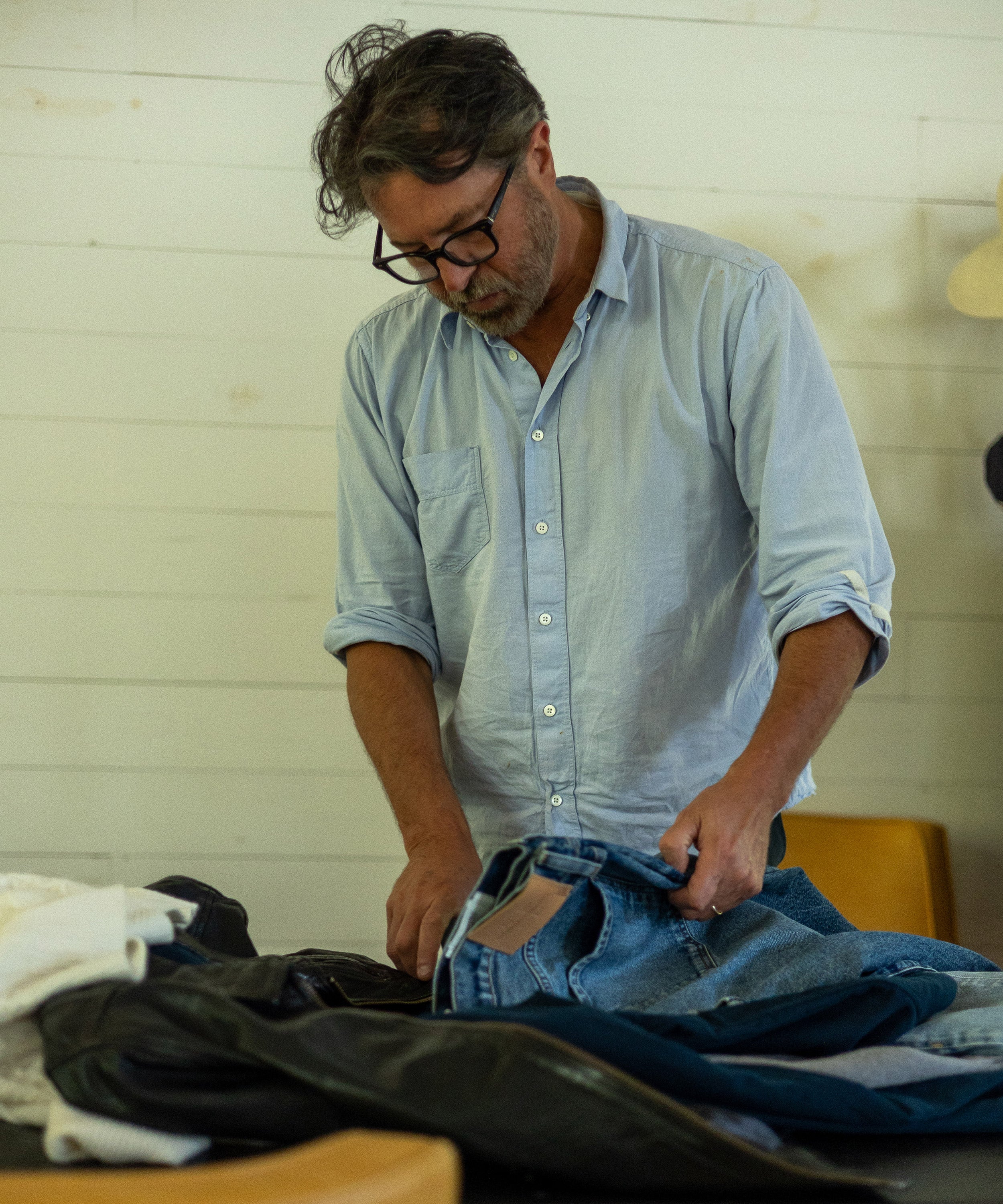 Billy Reid browses through Adler Jeans in various washes.