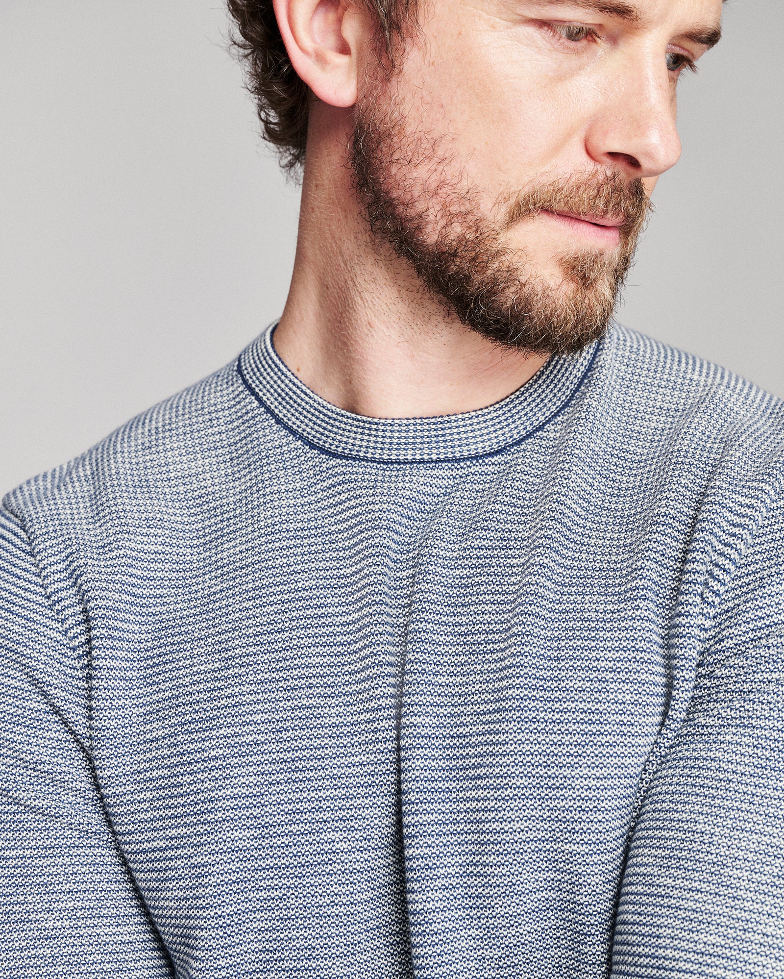 blue striped sweater worn by a brown haired model