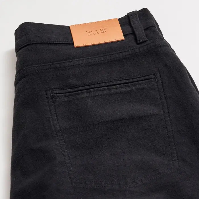 Black pants with a leather patch on a white background