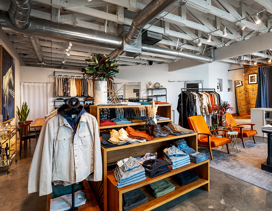 Interior of a clothing store with various garments on display.