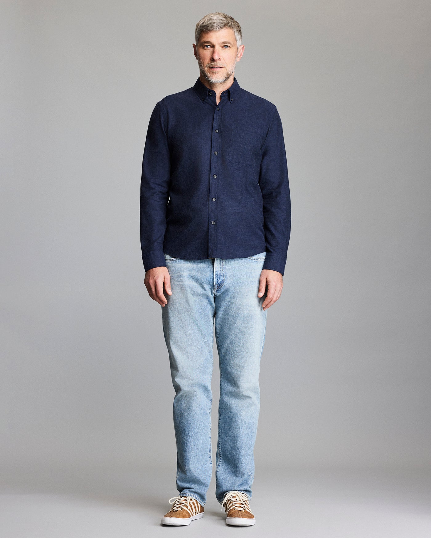 Model wears the navy button down shirt.
