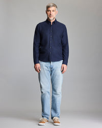Model wears the navy button down shirt.