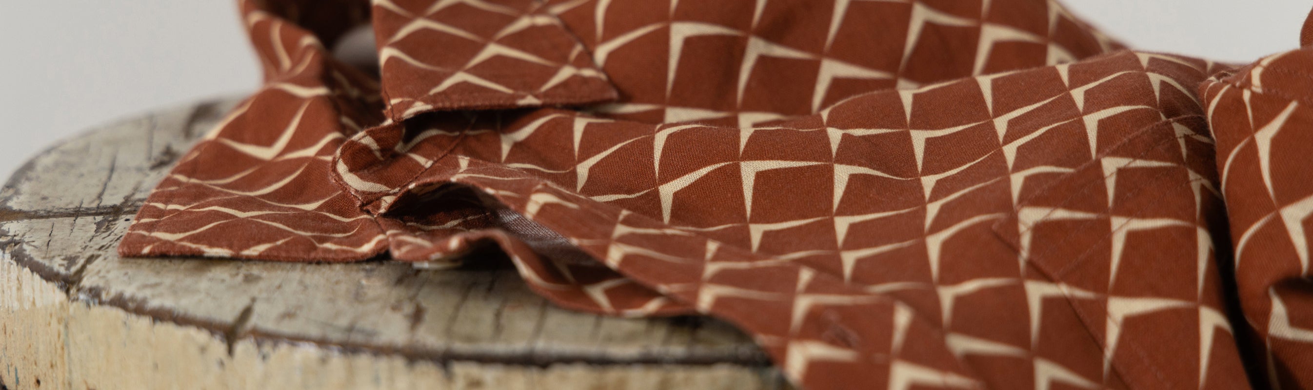 Brown fabric with a geometric pattern on a wooden surface