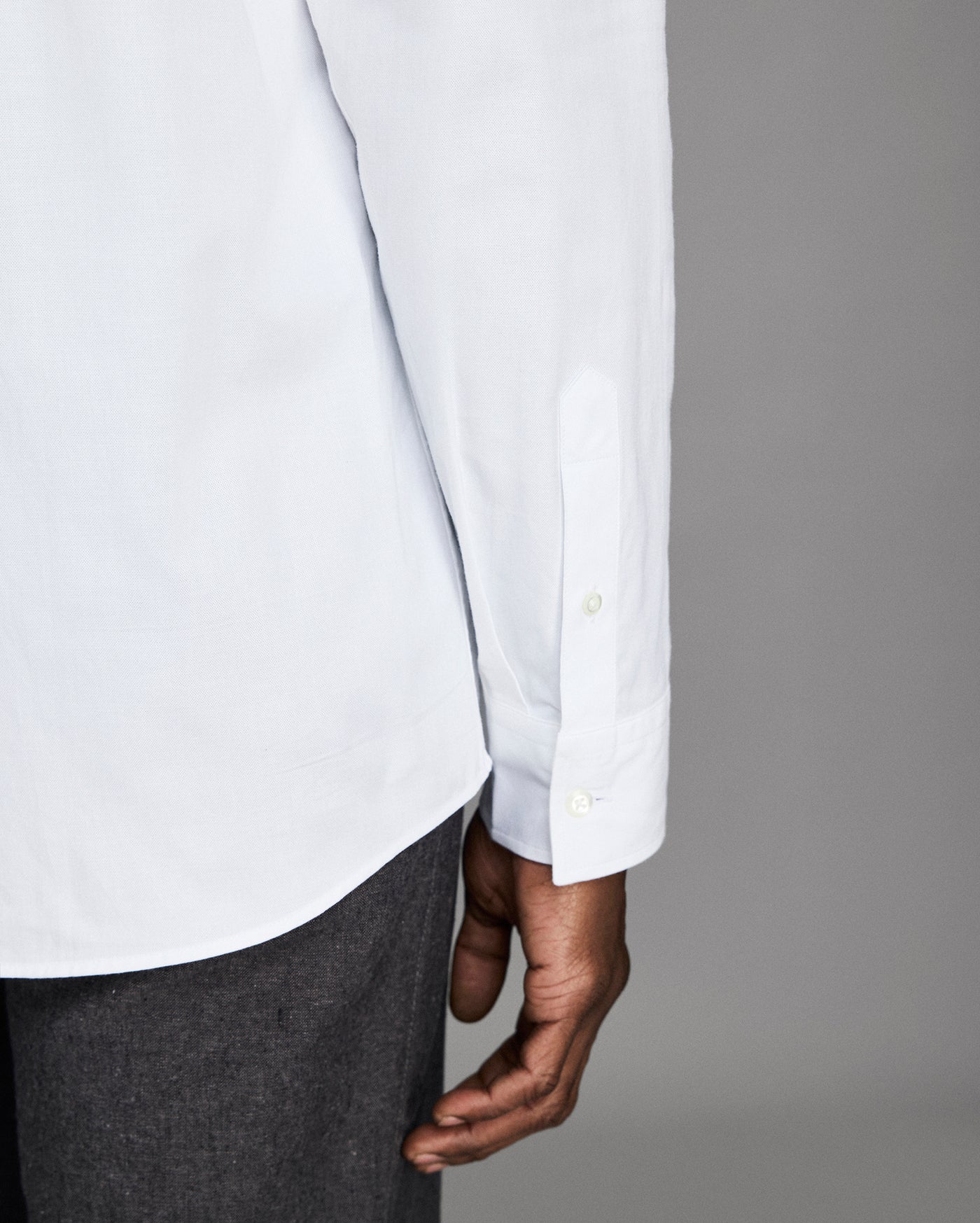 White shirt with rolled-up sleeves and a gray background