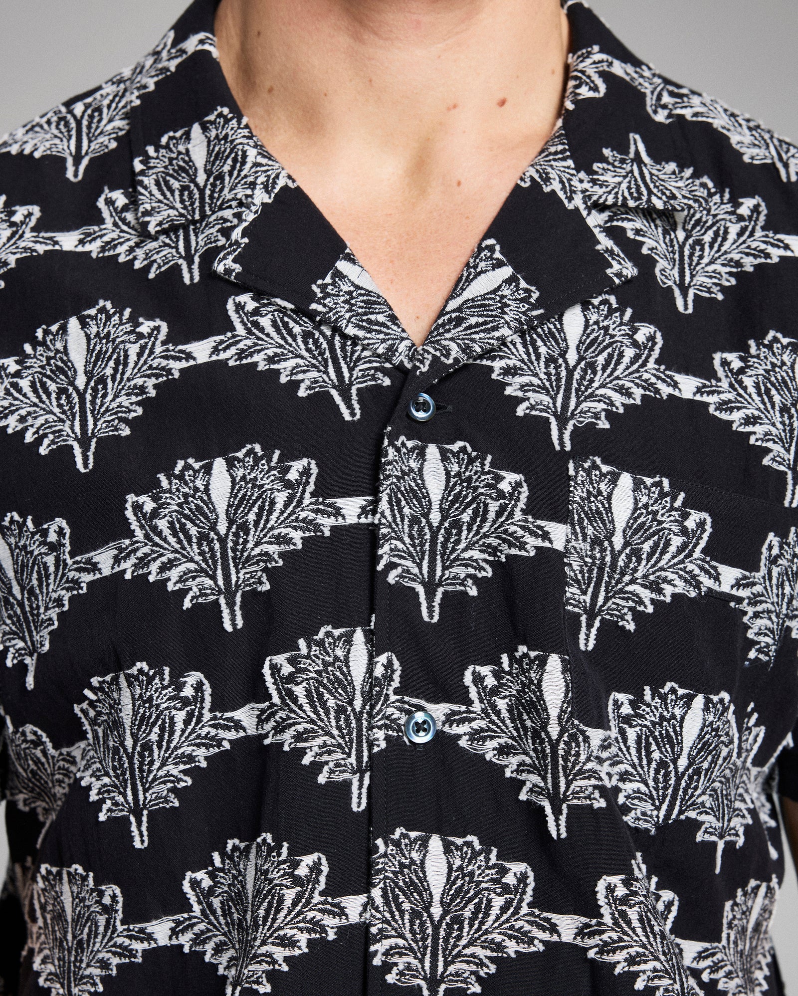 Close-up of a black shirt with white floral pattern
