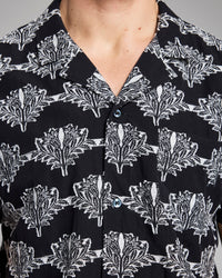 Close-up of a black shirt with white floral pattern