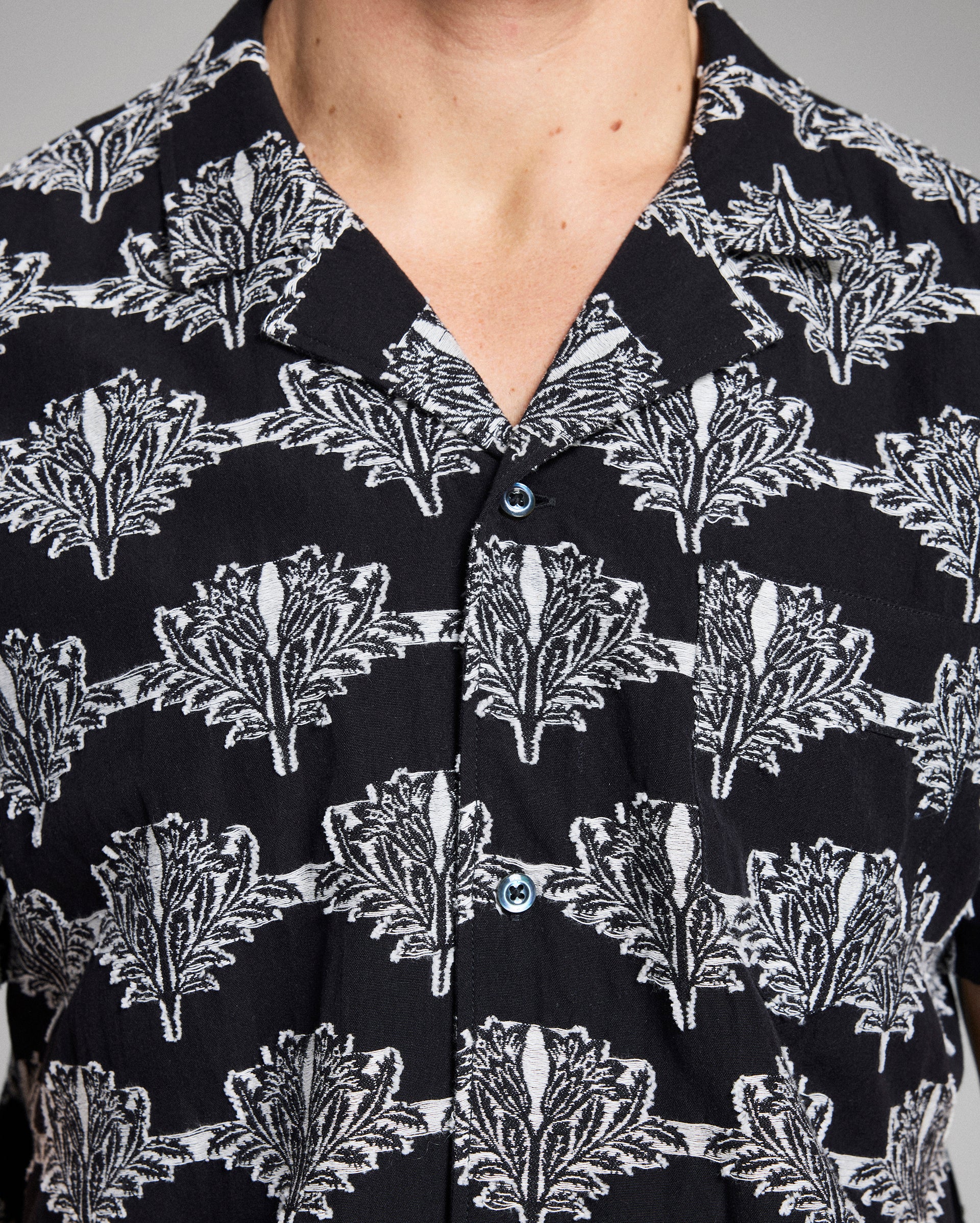Close-up of a black shirt with white floral pattern