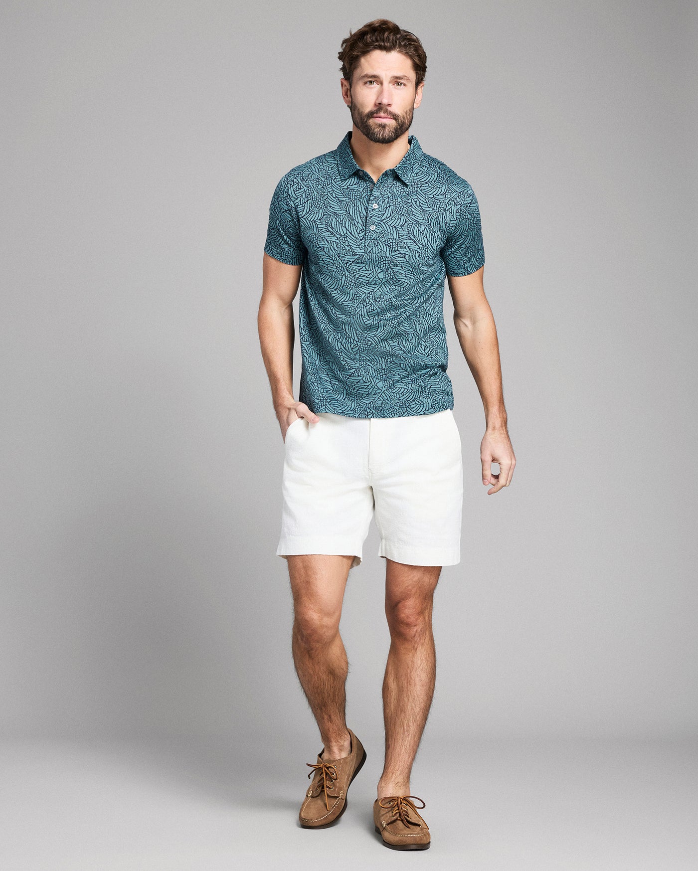 Green patterned polo shirt on a white background