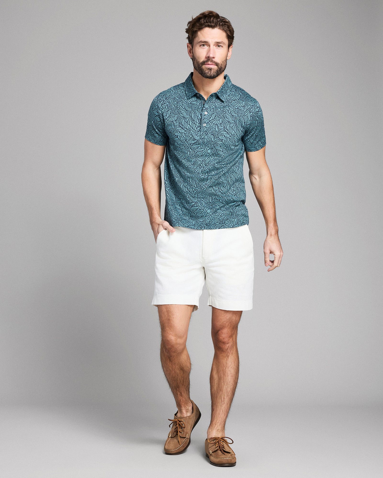 Green patterned polo shirt on a white background