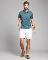 Green patterned polo shirt on a white background