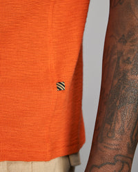 Photo of an orange shirt on a grey background