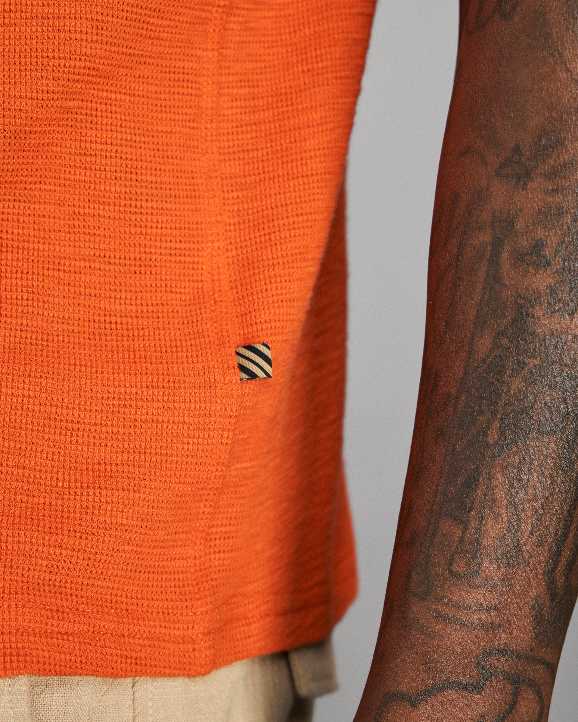 Photo of an orange shirt on a grey background