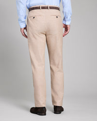 Beige pants worn by a person on a plain background