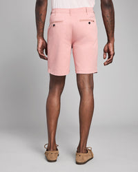 Person wearing pink shorts on a plain background