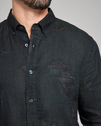 Black button-up shirt with subtle patterns on a neutral background