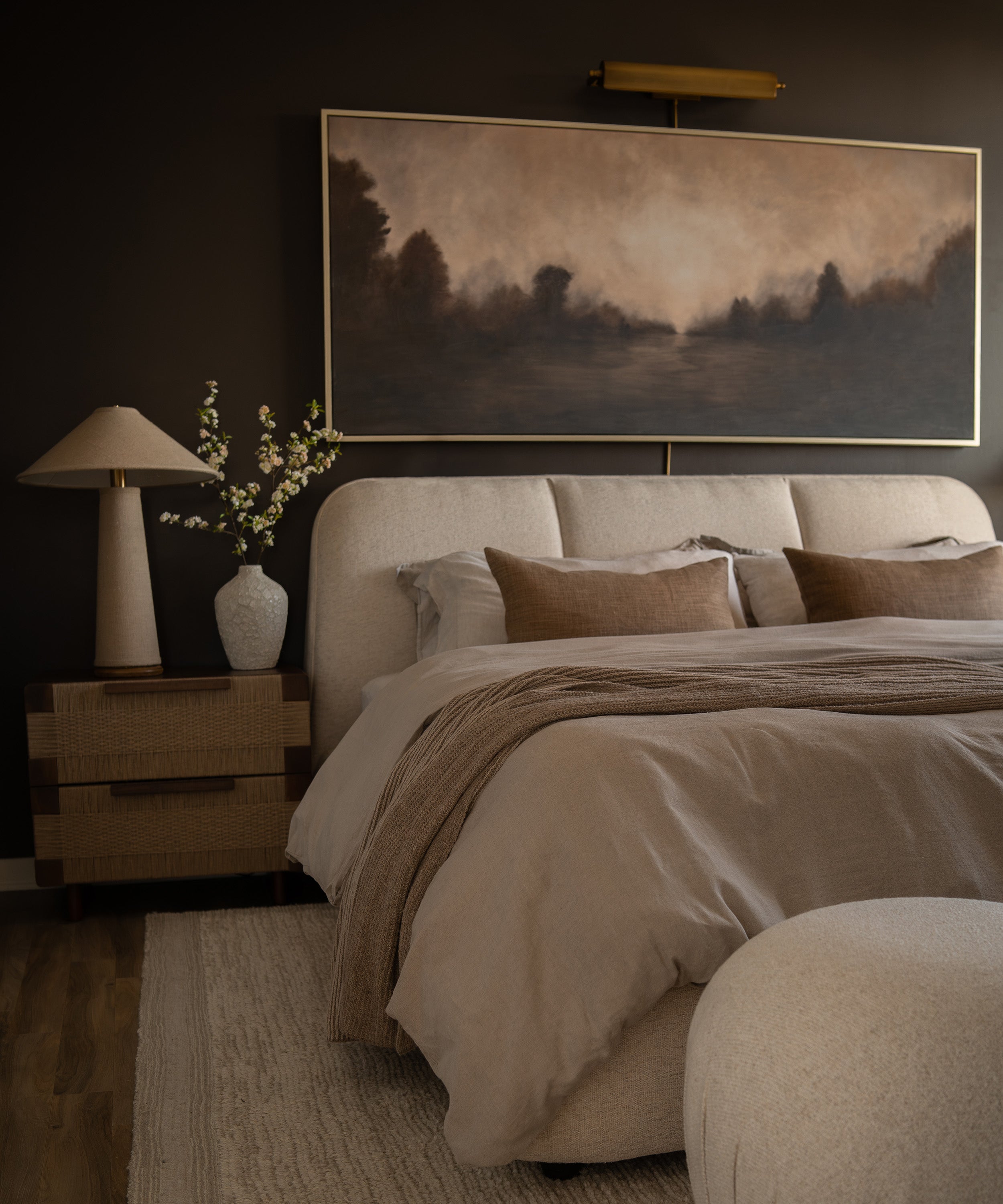 An earth-toned bedroom with a dark wall as the backdrop.