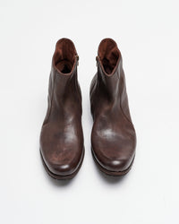 A pair of brown leather ankle boots with zippers on the sides, viewed from above on a plain white background.