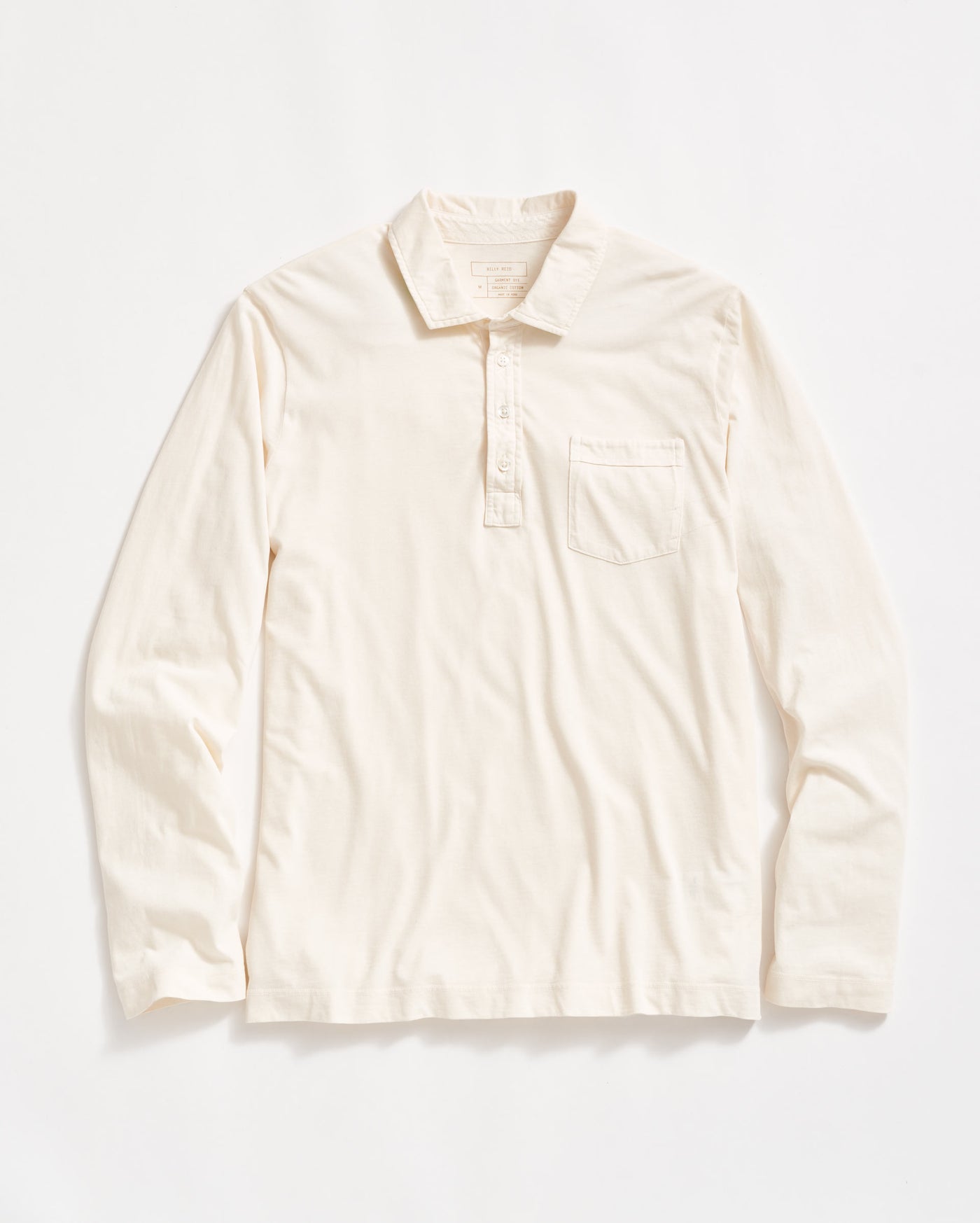 A long-sleeve, off-white collared shirt with a front pocket on the left chest and a partial button placket, laid flat on a white background.