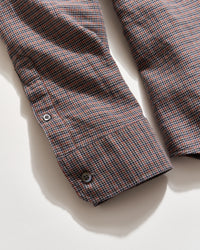 Plaid shirt with a button on a light background