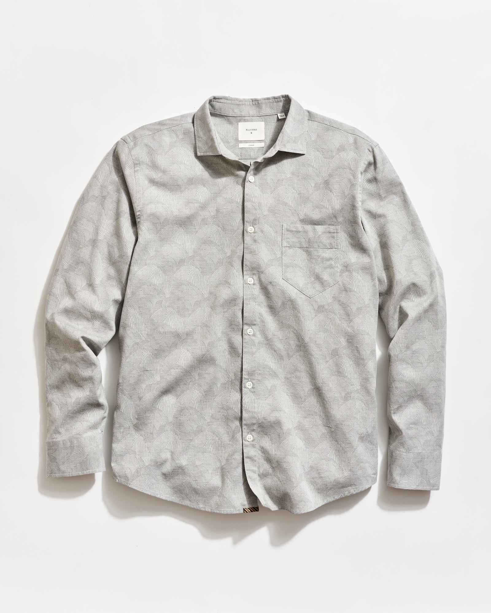 A light gray, long-sleeve button-up shirt with a subtle geometric pattern and a chest pocket, laid flat on a white background.
