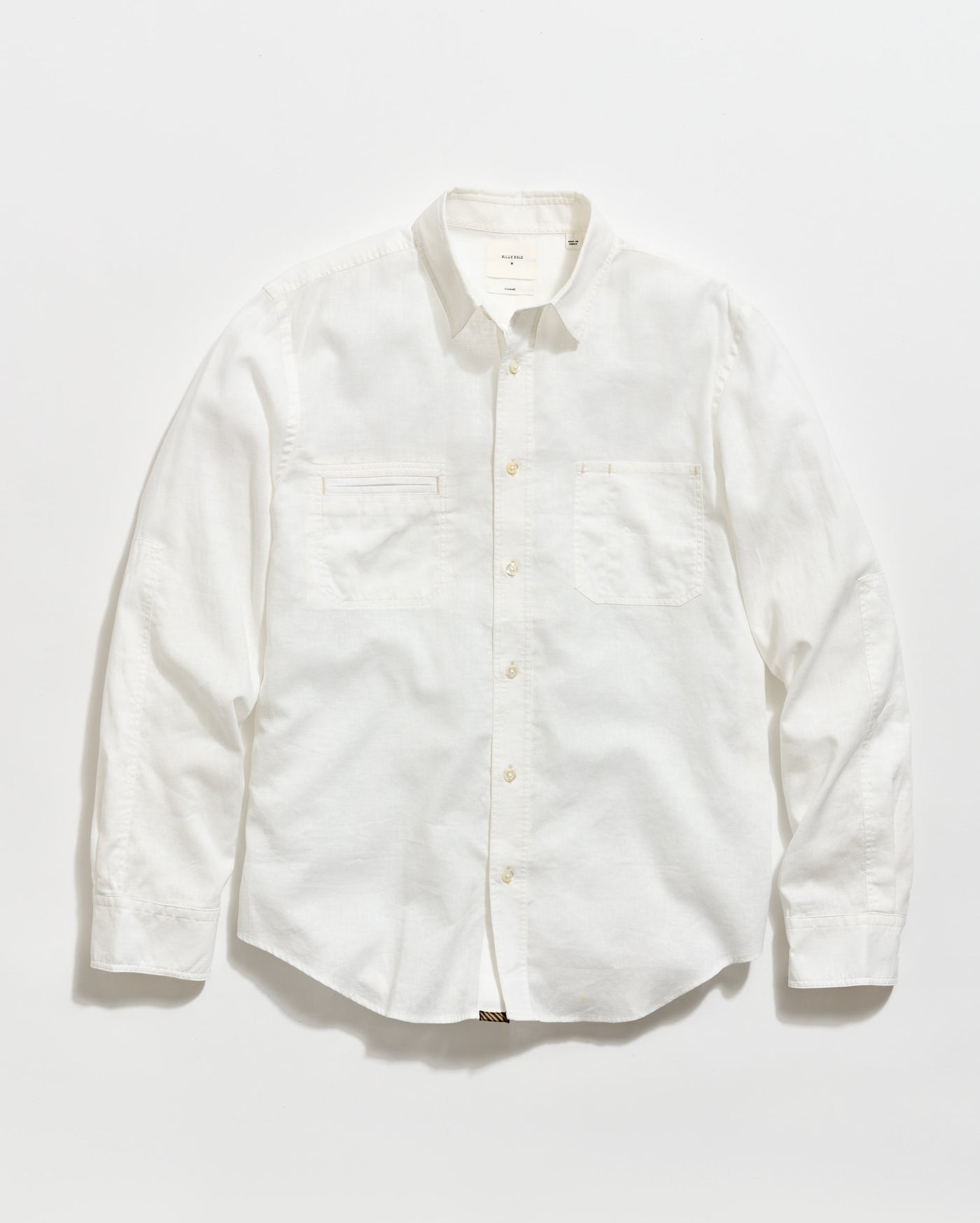 A long-sleeve, button-up white shirt with a collar and two chest pockets, laid flat on a plain white background.