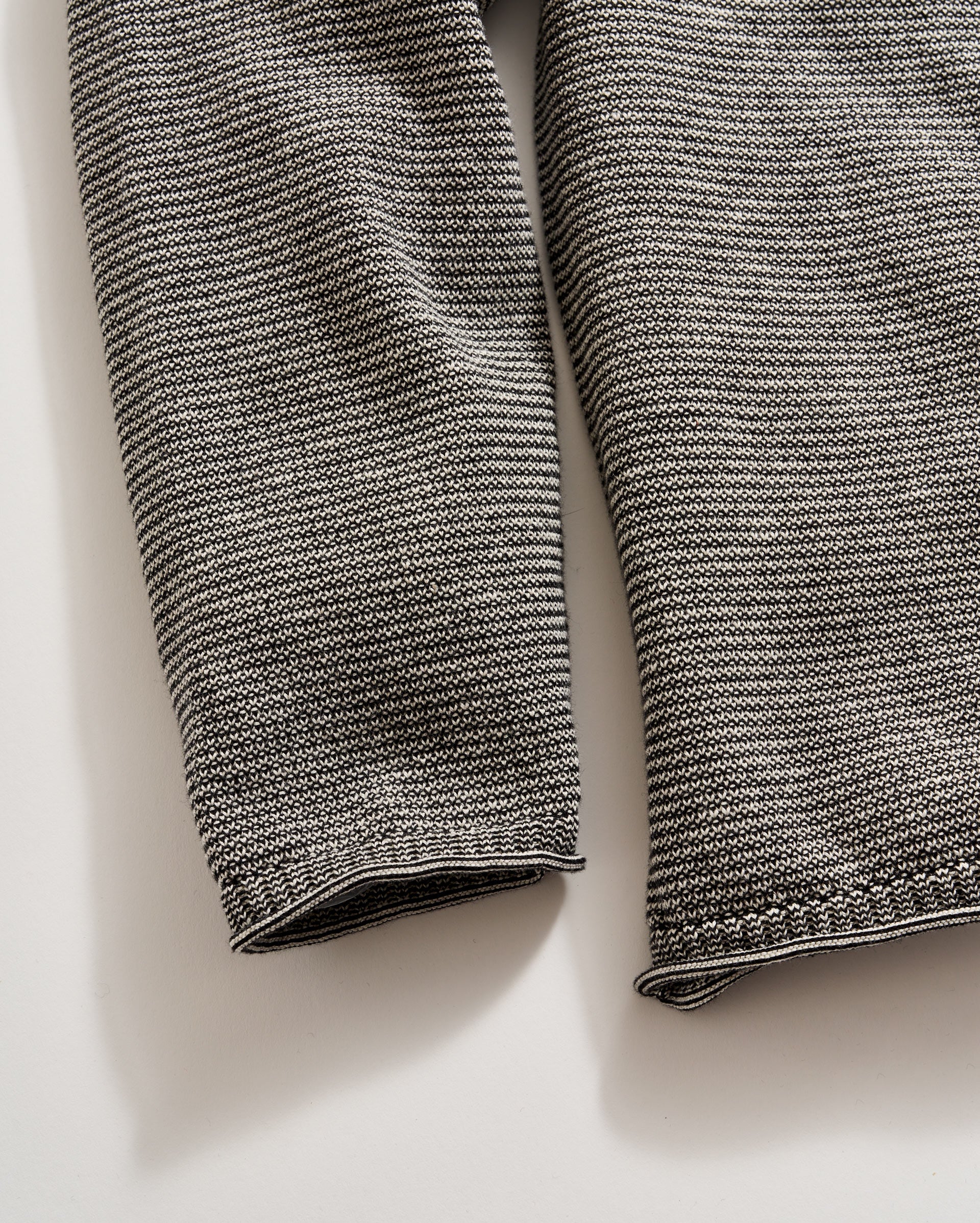 Close-up of a textured gray fabric on a light beige background