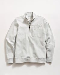 Light gray, long-sleeve pullover sweater with a quarter-zip front, black zipper pull, ribbed cuffs and hem, and a textured waffle pattern. A small chest pocket with a diagonal opening is on the left side.