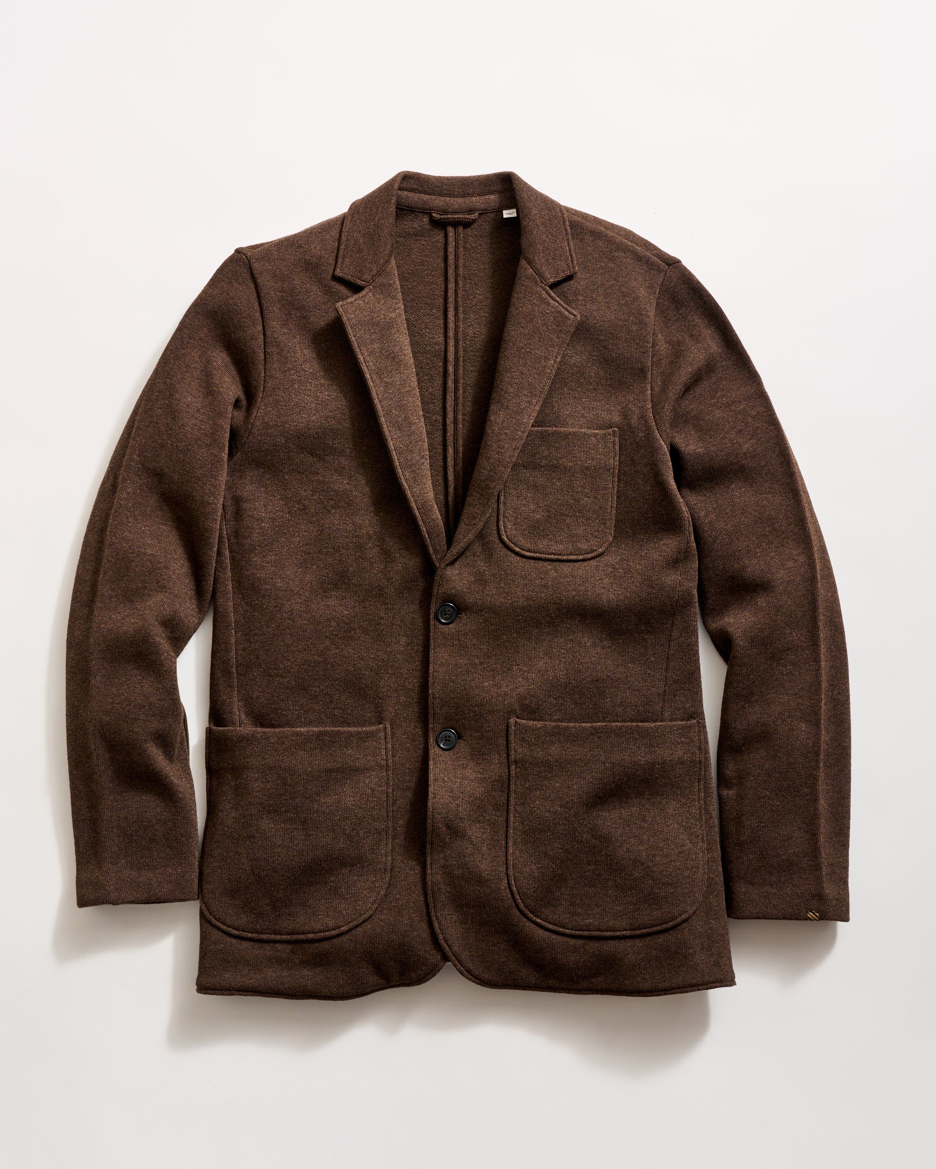 A brown wool blazer with two large front pockets, a chest pocket, and two black buttons, displayed flat on a white background.