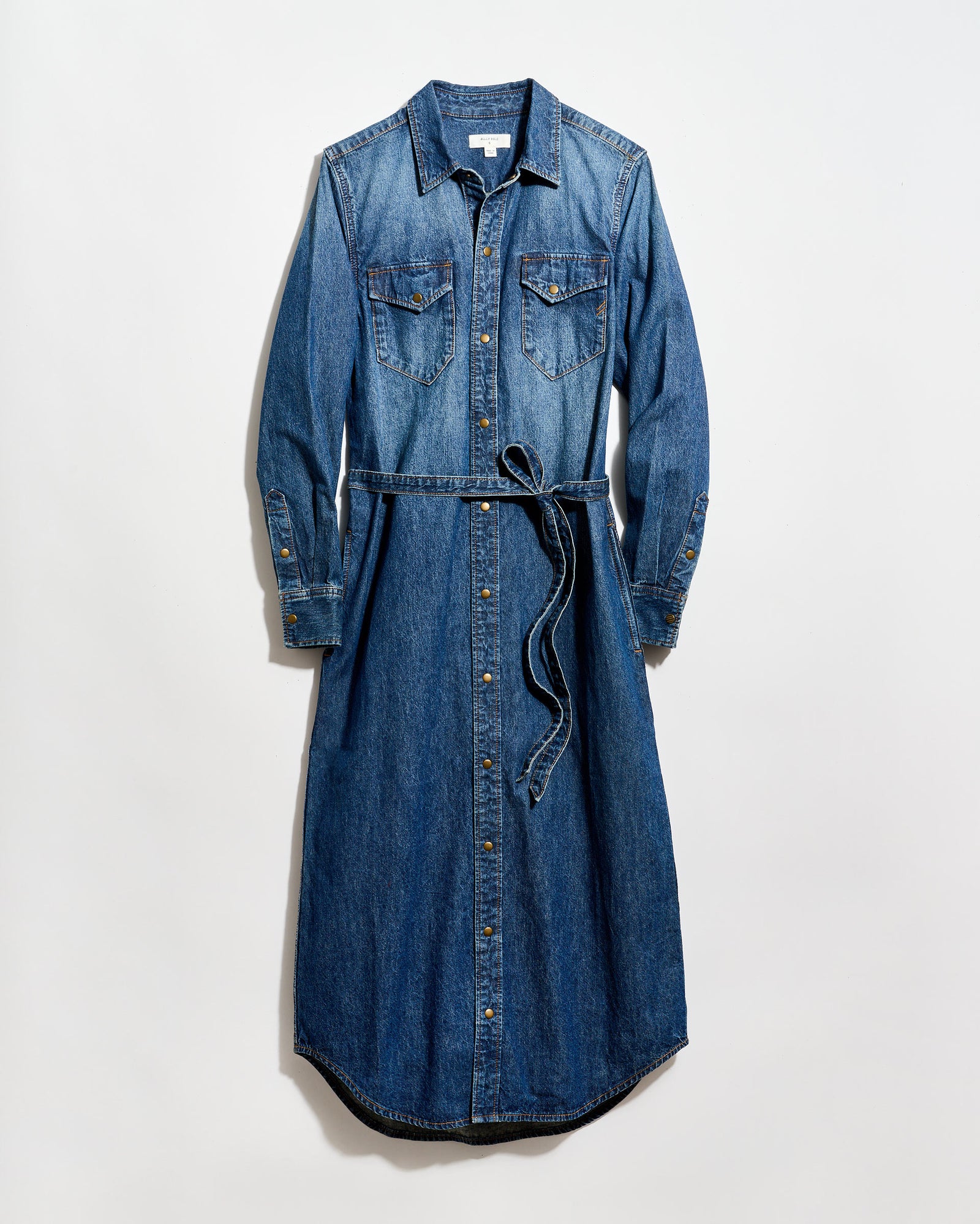 A long-sleeve, button-down denim dress with a collar, two chest pockets, and a matching denim waist tie, laid flat on a white background.