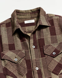 Plaid dress with a collar and buttons on a white background