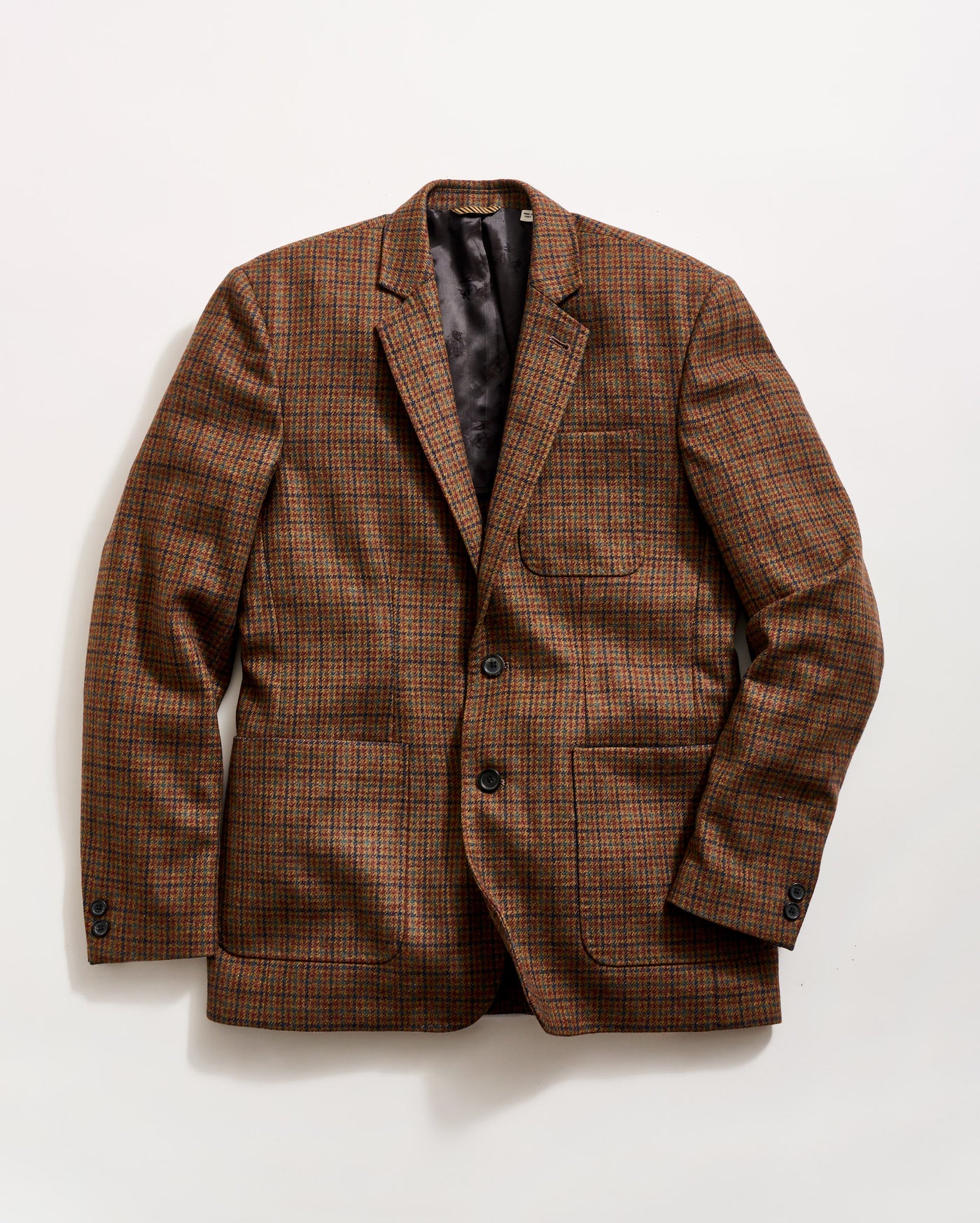 A brown plaid blazer with a notched lapel, two buttons, and three front pockets, laid flat on a white background.