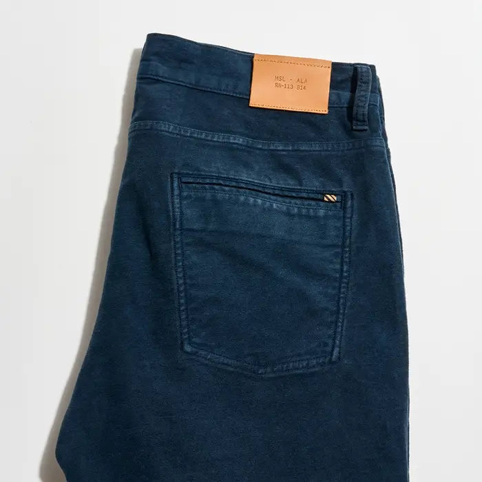 Blue jeans with a brand label on a white background