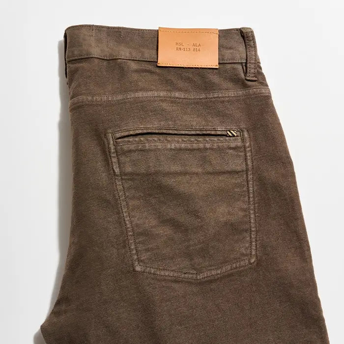 Brown pants with a leather label on a white background