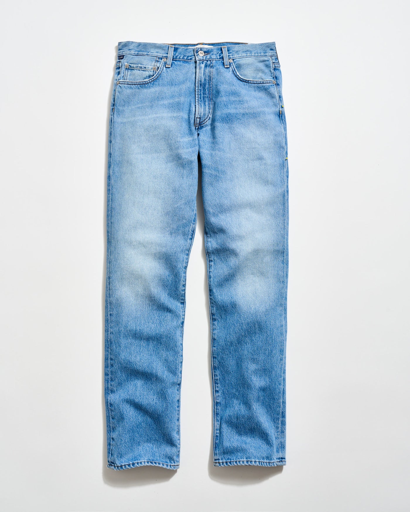 A pair of light blue, straight-leg jeans with a classic five-pocket design, laid flat on a white background.
