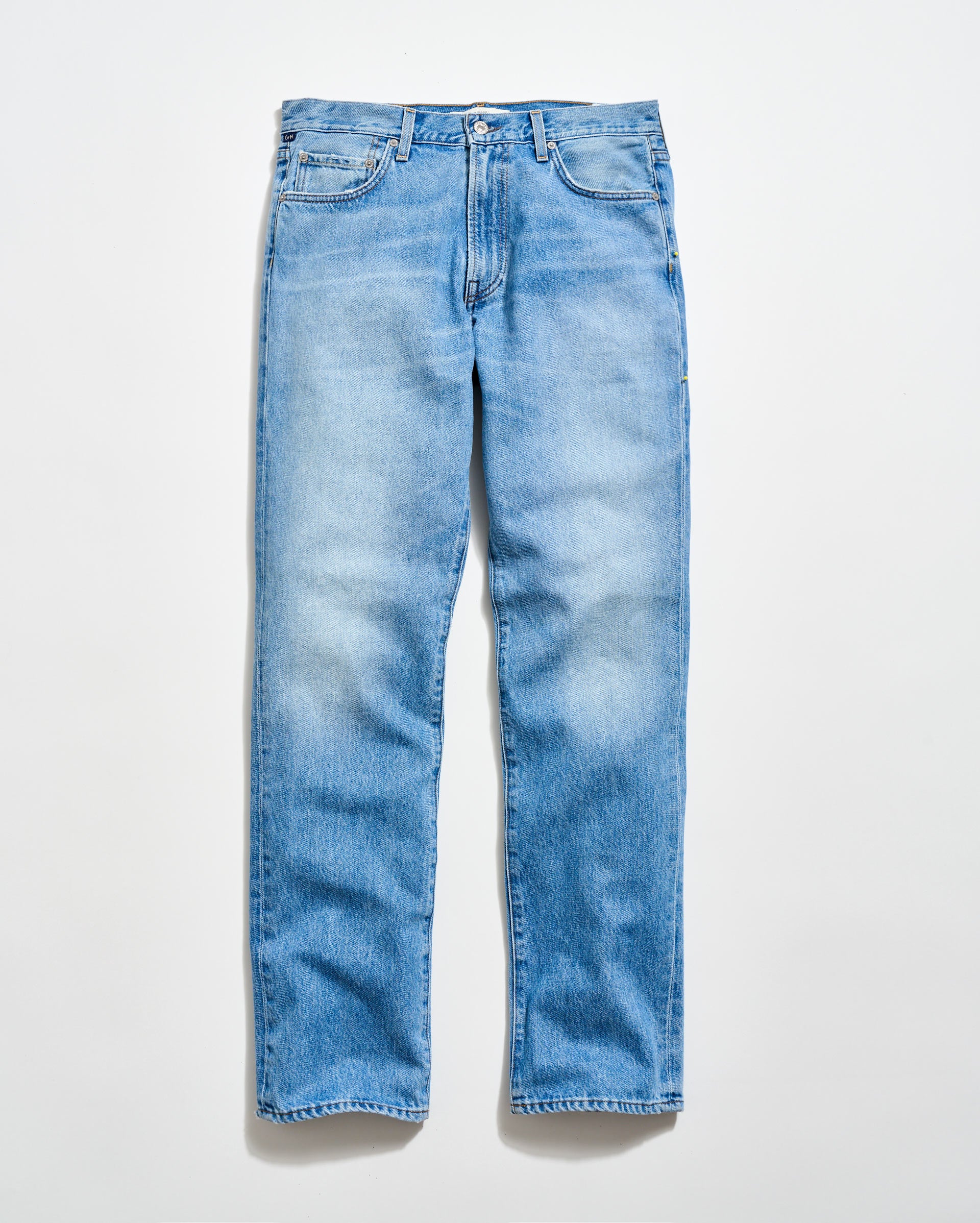 A pair of light blue, straight-leg jeans with a classic five-pocket design, laid flat on a white background.