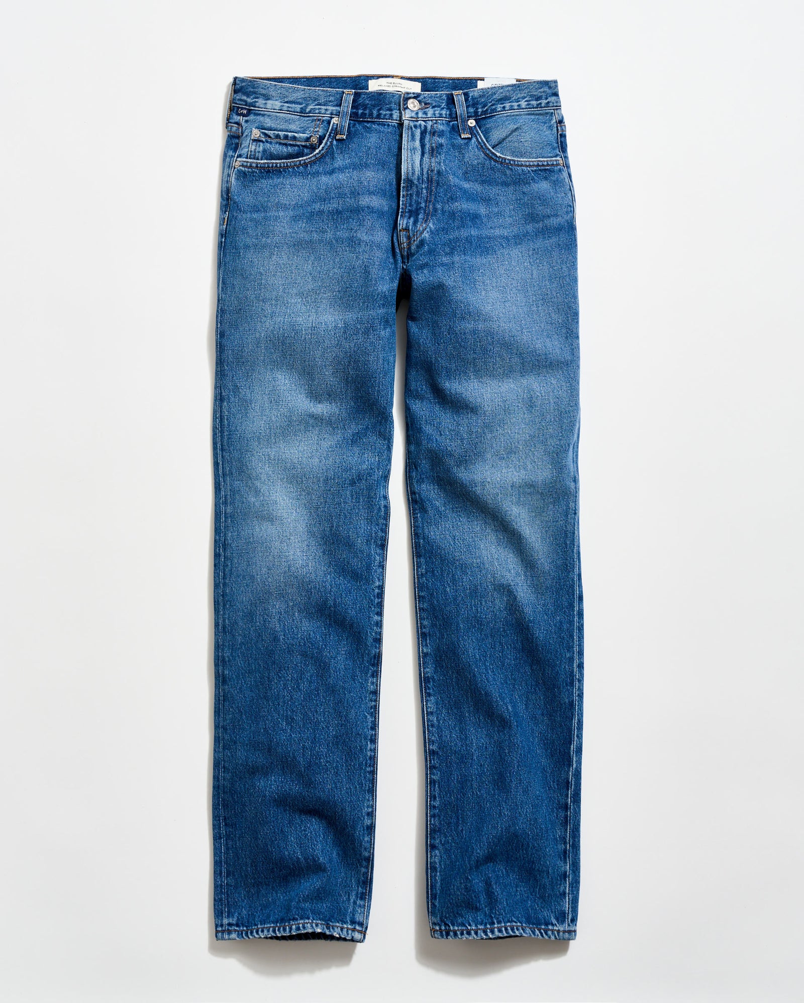 A pair of classic blue denim jeans with a straight-leg cut, five pockets, and a button fly, laid flat on a light background.