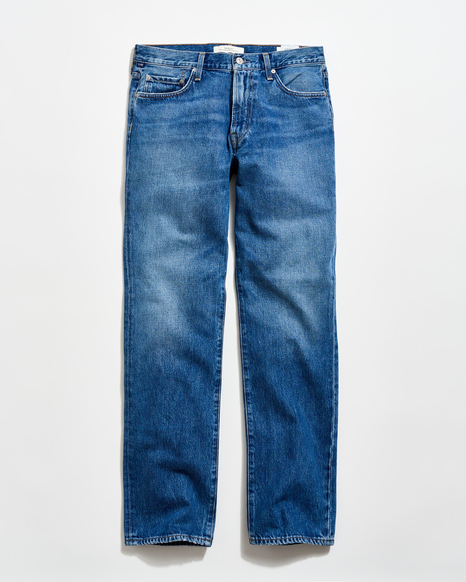A pair of classic blue denim jeans with a straight-leg cut, five pockets, and a button fly, laid flat on a light background.