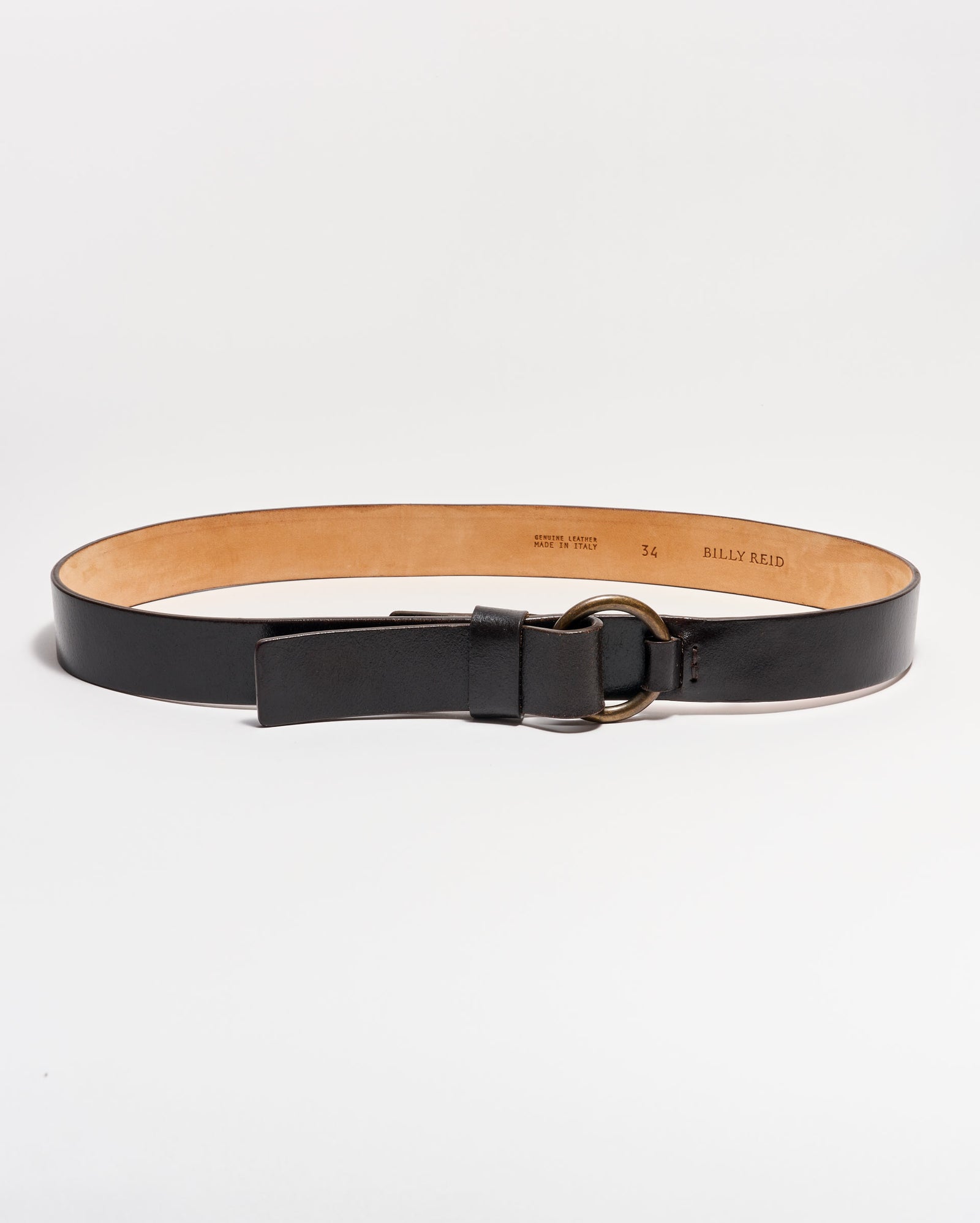 A black leather belt with a tan interior, featuring a round metal buckle and a single loop, displayed on a white background.