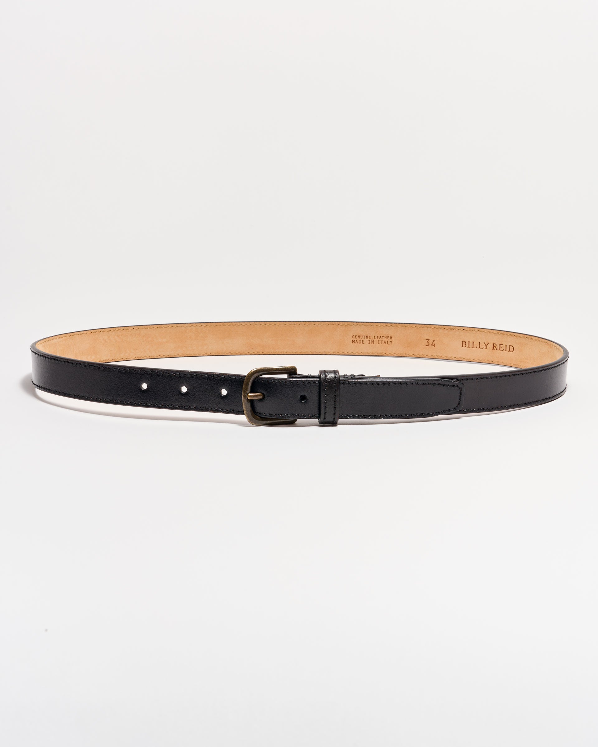 A black leather belt with a matte silver buckle is laid flat on a white background. The belt interior is tan, and size and brand details are stamped on the inside.