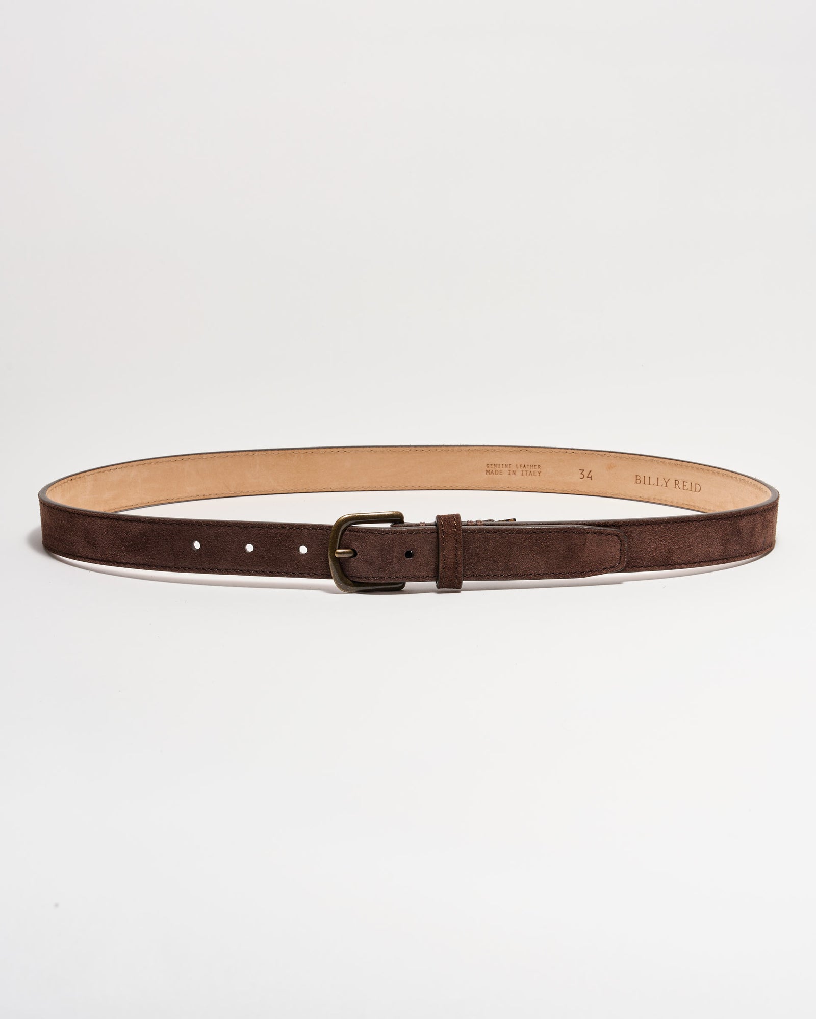 A brown suede leather belt with a brass buckle, laid flat in a circular shape on a white background. The interior of the belt is tan, and several adjustment holes are visible.