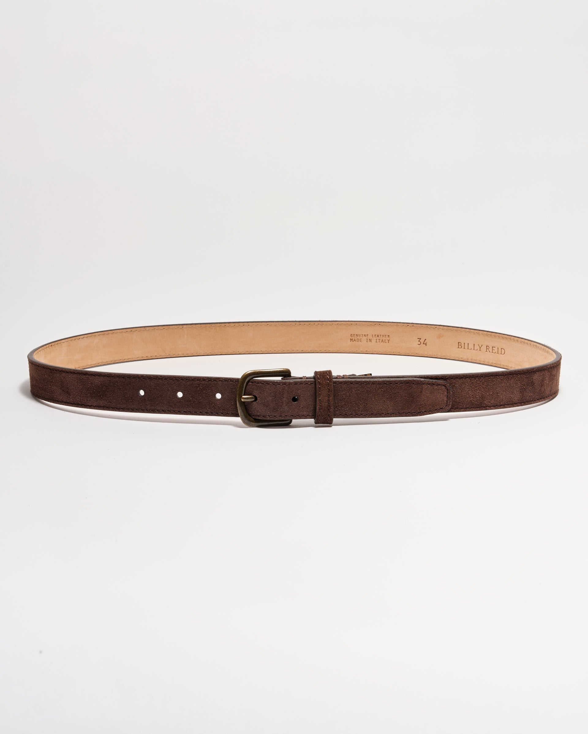 A brown suede leather belt with a brass buckle, laid flat in a circular shape on a white background. The interior of the belt is tan, and several adjustment holes are visible.