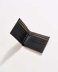 An open black leather wallet with brown stitching, showing multiple card slots and a patterned interior, photographed on a white background.