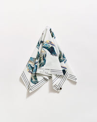 A folded white handkerchief hangs against a white background, featuring colorful bird illustrations and black border lines. The text Bradley Gordon and Billy Reid is visible near one corner.