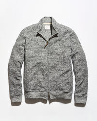 A gray heathered zip-up sweater jacket with a mock neck collar and a brown leather zipper pull, displayed flat against a white background.