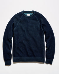 A dark navy blue crewneck sweater with raglan sleeves, laid flat against a clean white background.