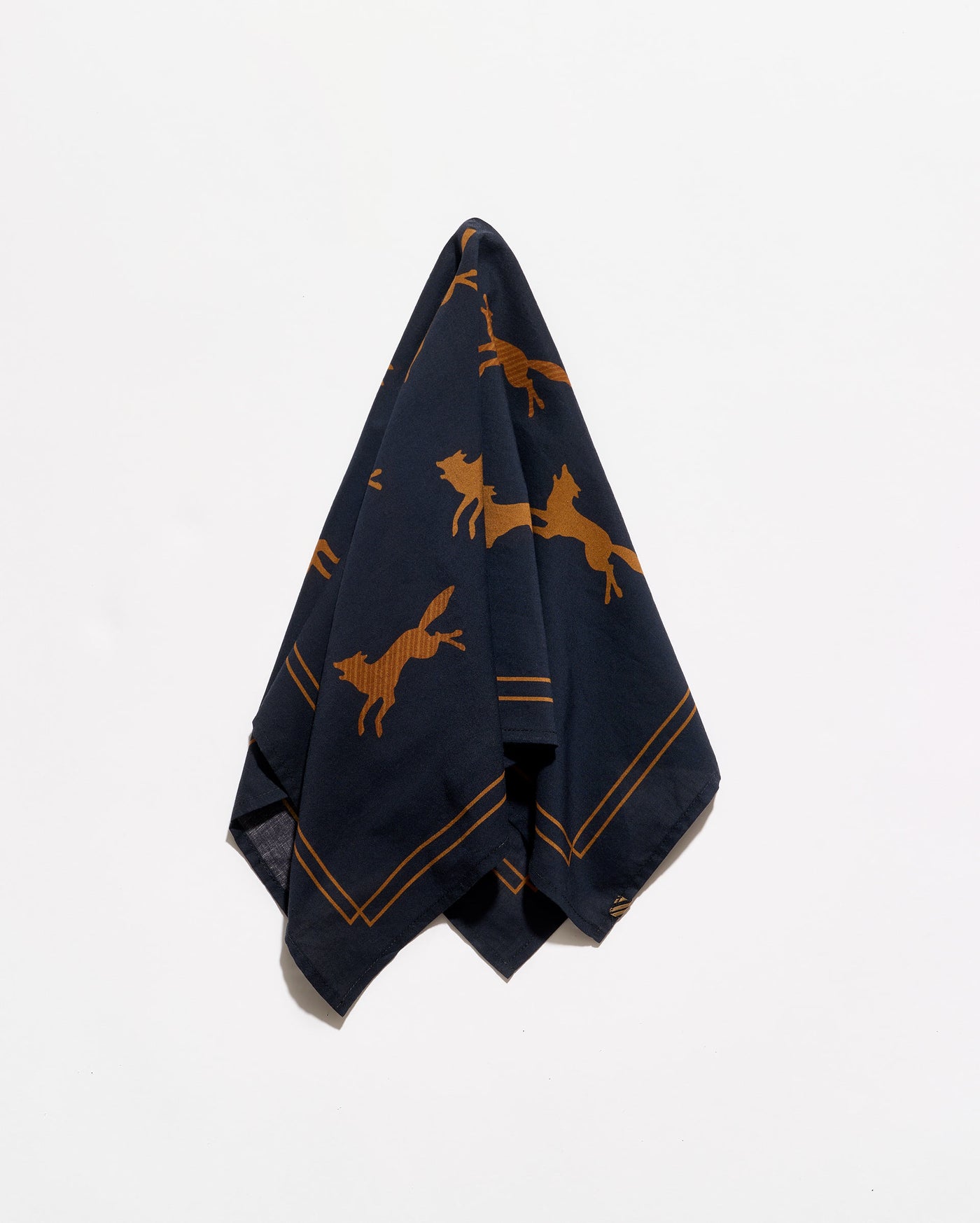 A navy blue silk scarf with a pattern of golden-brown leaping foxes and double-line borders, photographed against a clean white background.