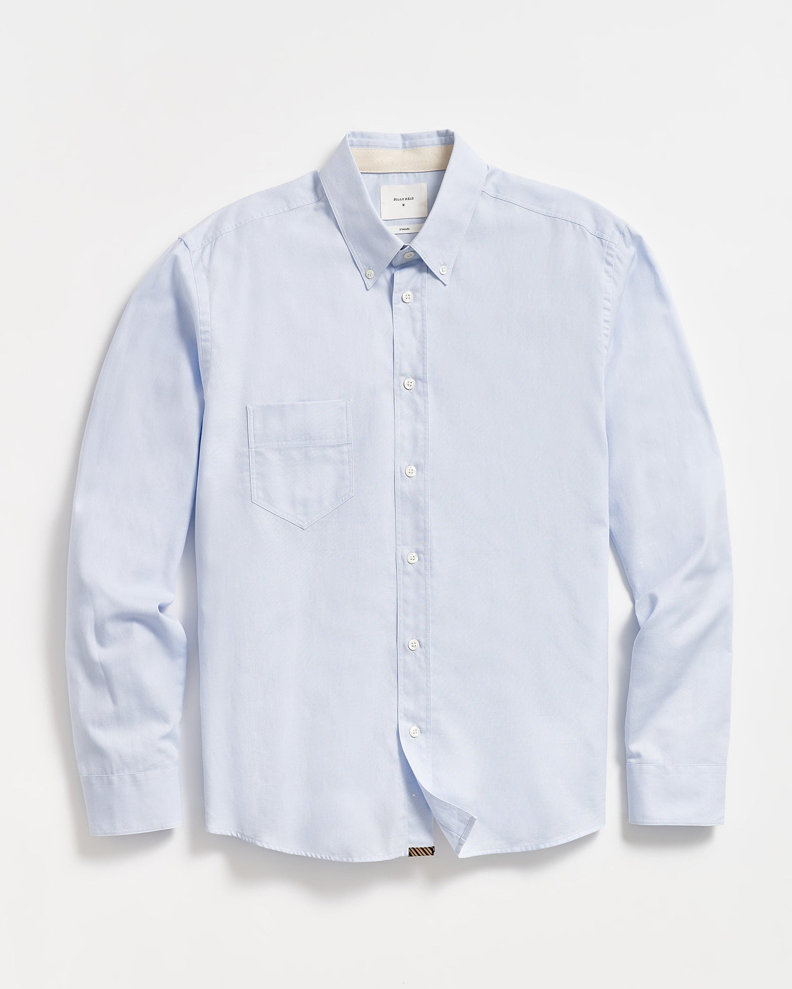 A light blue, long-sleeve button-down shirt with a single chest pocket, buttoned collar, and white buttons, laid flat on a white background.