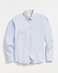 A light blue, long-sleeve button-down shirt with a single chest pocket, buttoned collar, and white buttons, laid flat on a white background.