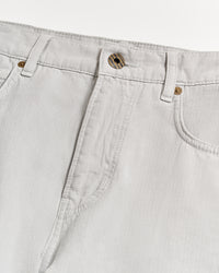 Close-up of the waist and upper leg area of light grey jeans with visible stitching, belt loops, a front button, and part of the pockets on a white background.