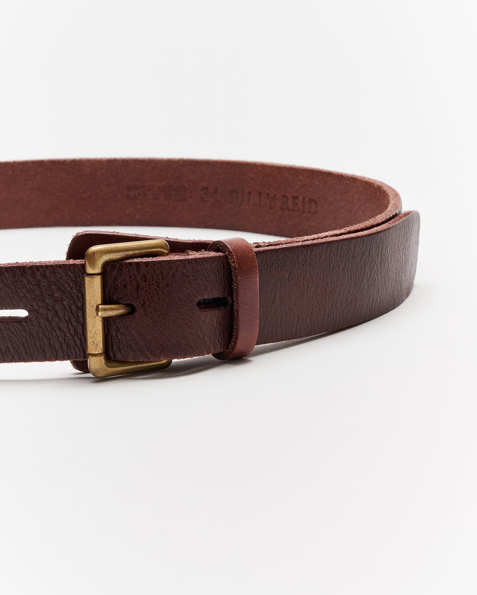 A close-up of a brown leather belt with a brass buckle displayed against a plain white background.